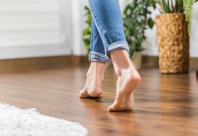 woman walking barefoot, radiant floor heating
